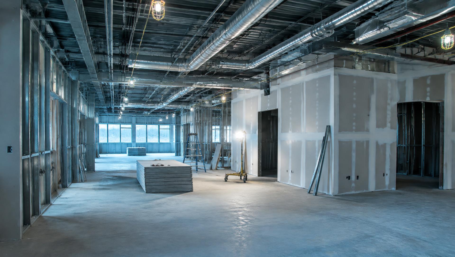 Interior build-out in progress with metal framing and drywall